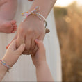 Load image into Gallery viewer, Two pairs of hands (mum and daughter) holding each other both wearing matching bracelets.