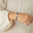 Load image into Gallery viewer, Child wearing a floral bracelet with a star charm
