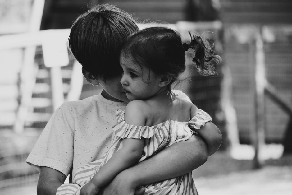 A big brother carrying his little sister