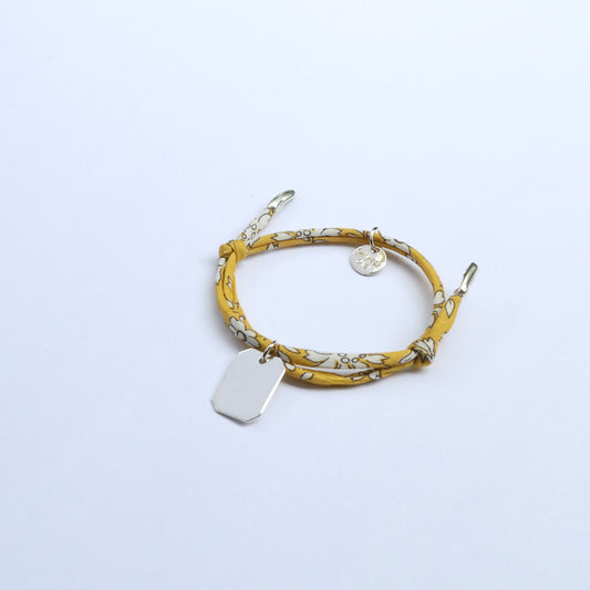 Yellow patterned bracelet with a silver bar pendant for children