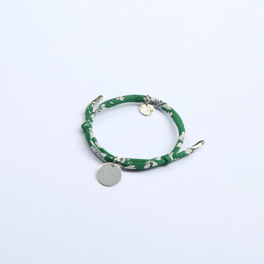 Green bracelet with floral pattern and silver round pendant for children