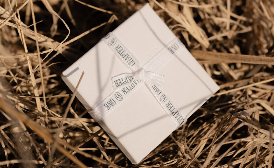 Eco friendly packaging with recyclable ribbon and box on a bed of straw