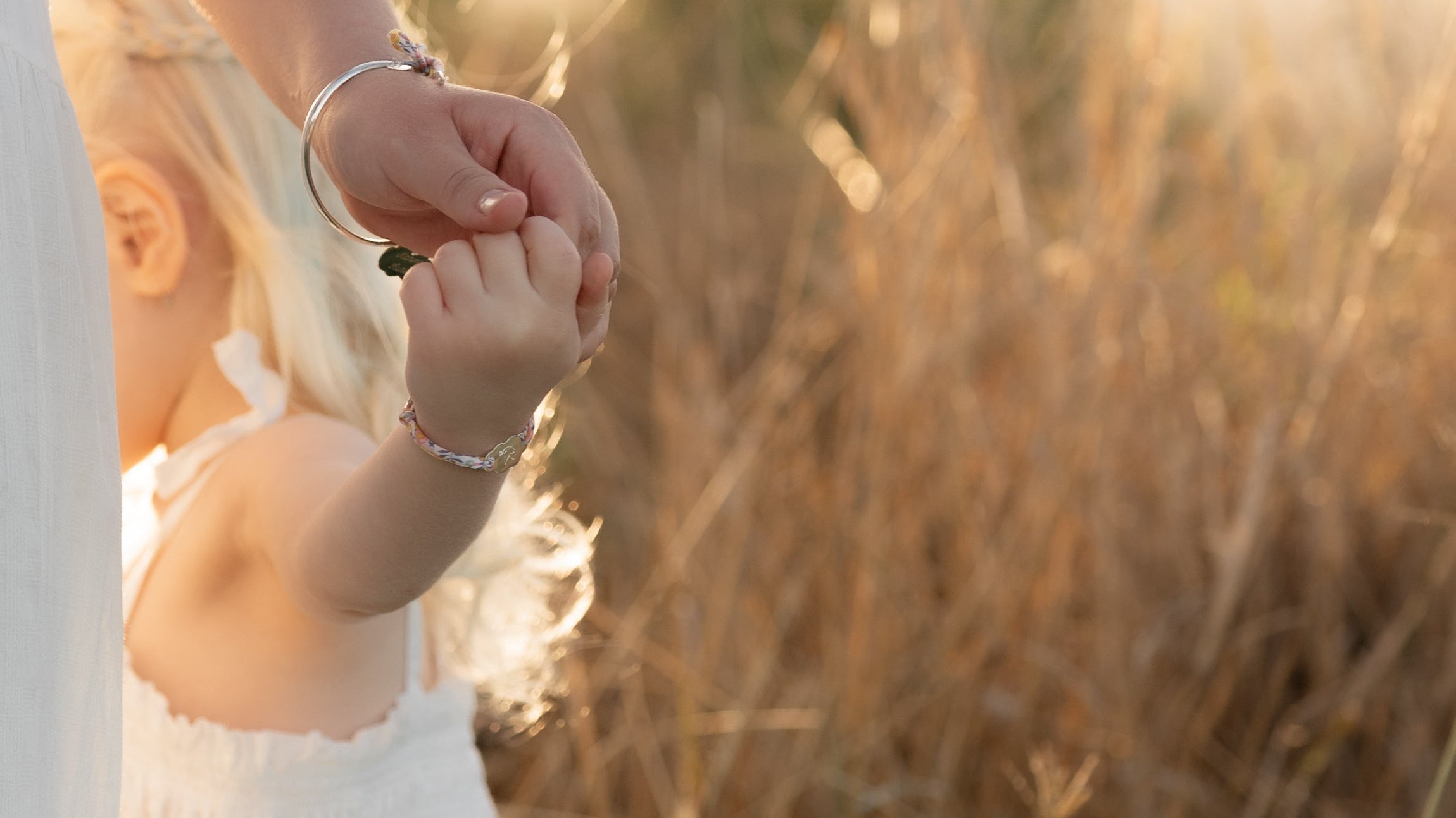 Mummy and Me Set of bracelets, mum wears a sterling silver bangle with pendant matching her little one bracelet both engraved with names and symbols