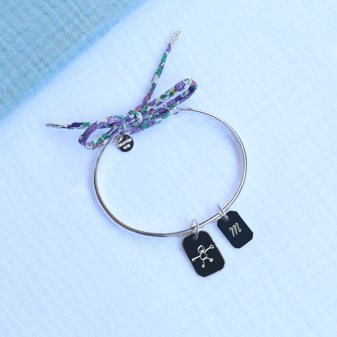 Silver bangle for women, with two bar pendants, one engraved with a child's drawing the other with an initial 