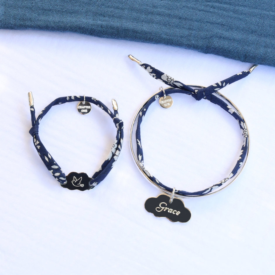 Jewellery set made of a woman bangle and a child bracelet with custom engraved silver charms.