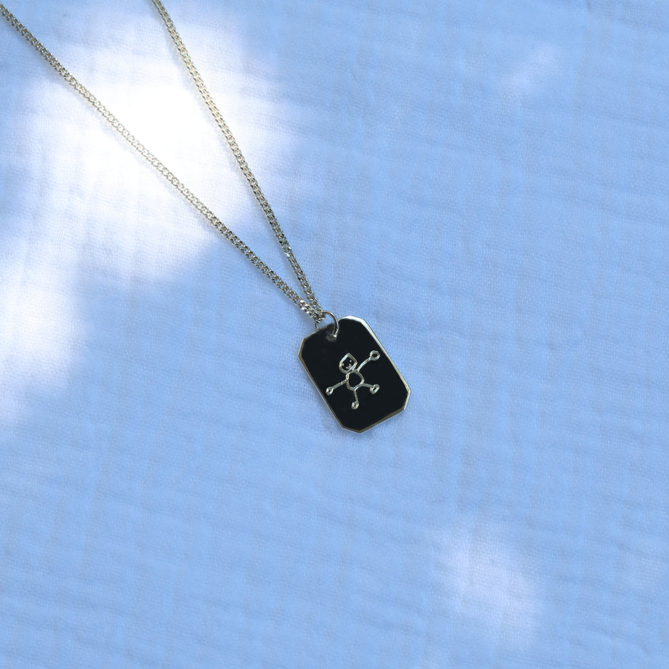 Child's drawing engraved on a sterling silver necklace