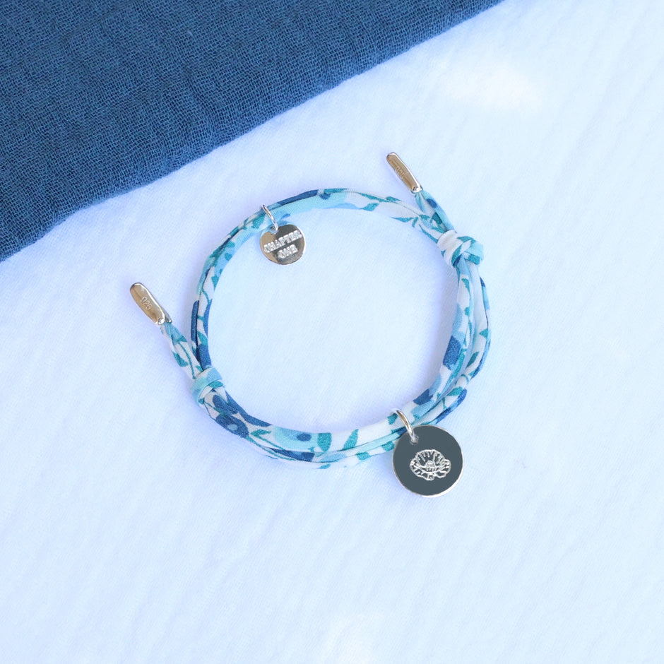 Cord bracelet with sterling silver pendant, engraved with birth flower