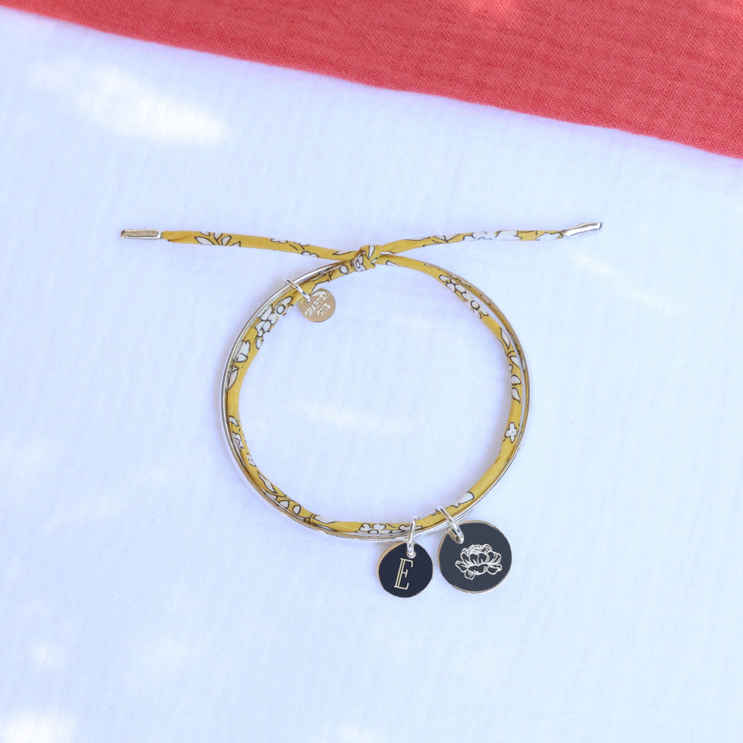 Silver bracelet with floral ribbon and charms engraved with initial and birth flower