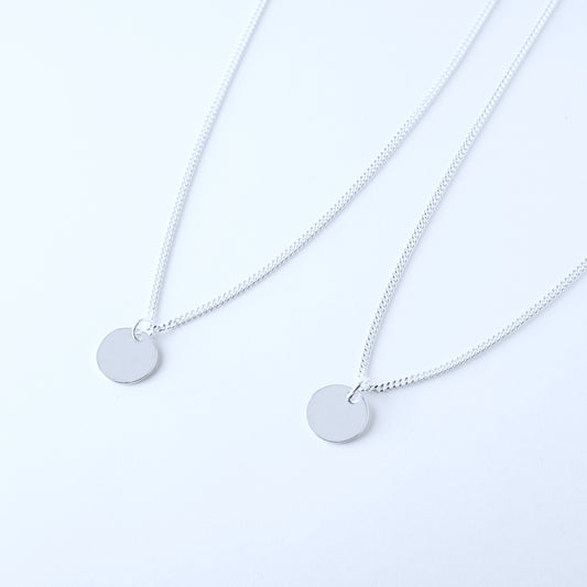 Two silver necklaces with round engravable pendants 