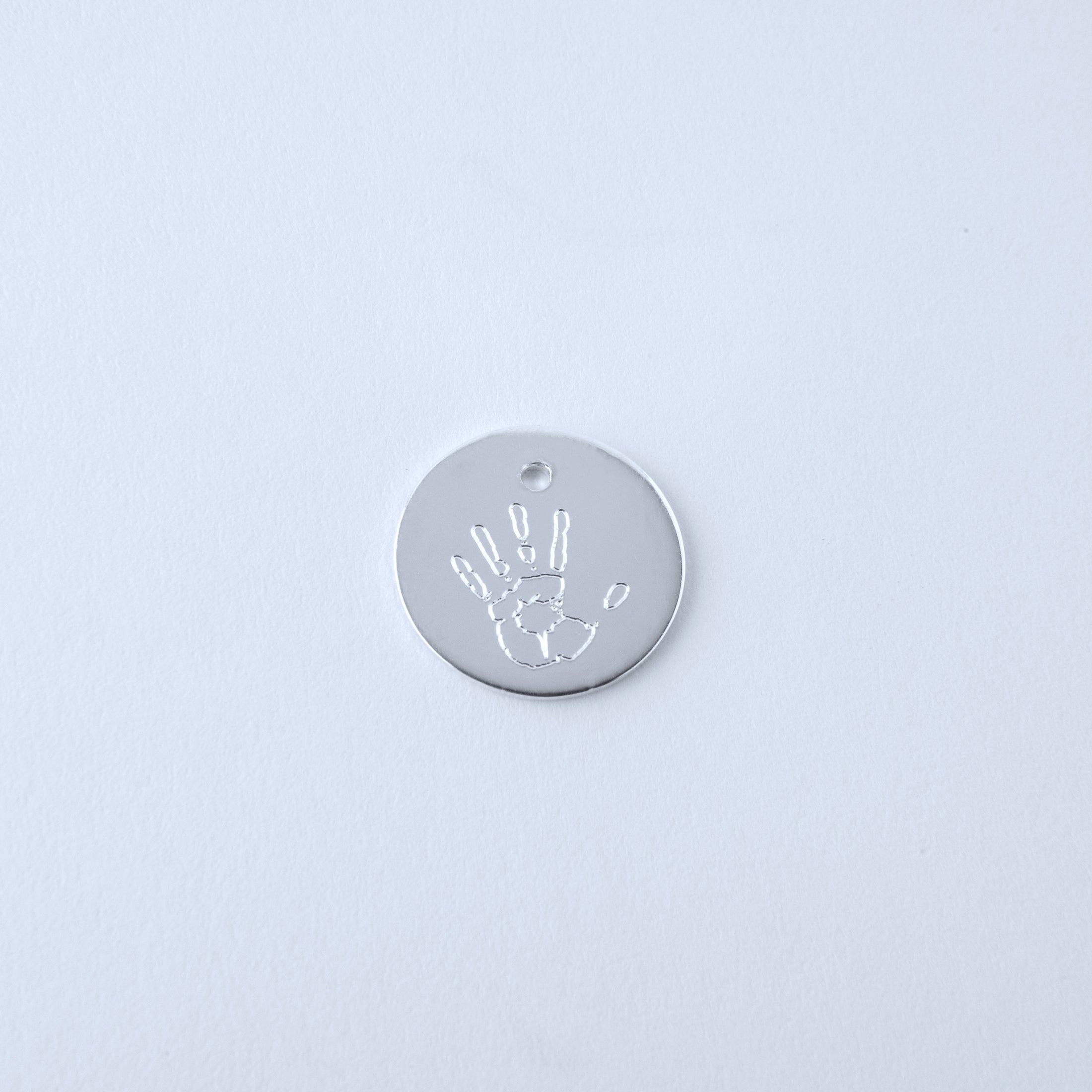 Silver pendant with handprint design engraved