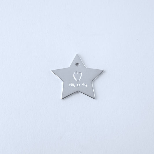 Silver star-shaped pendant with engraved child's drawing