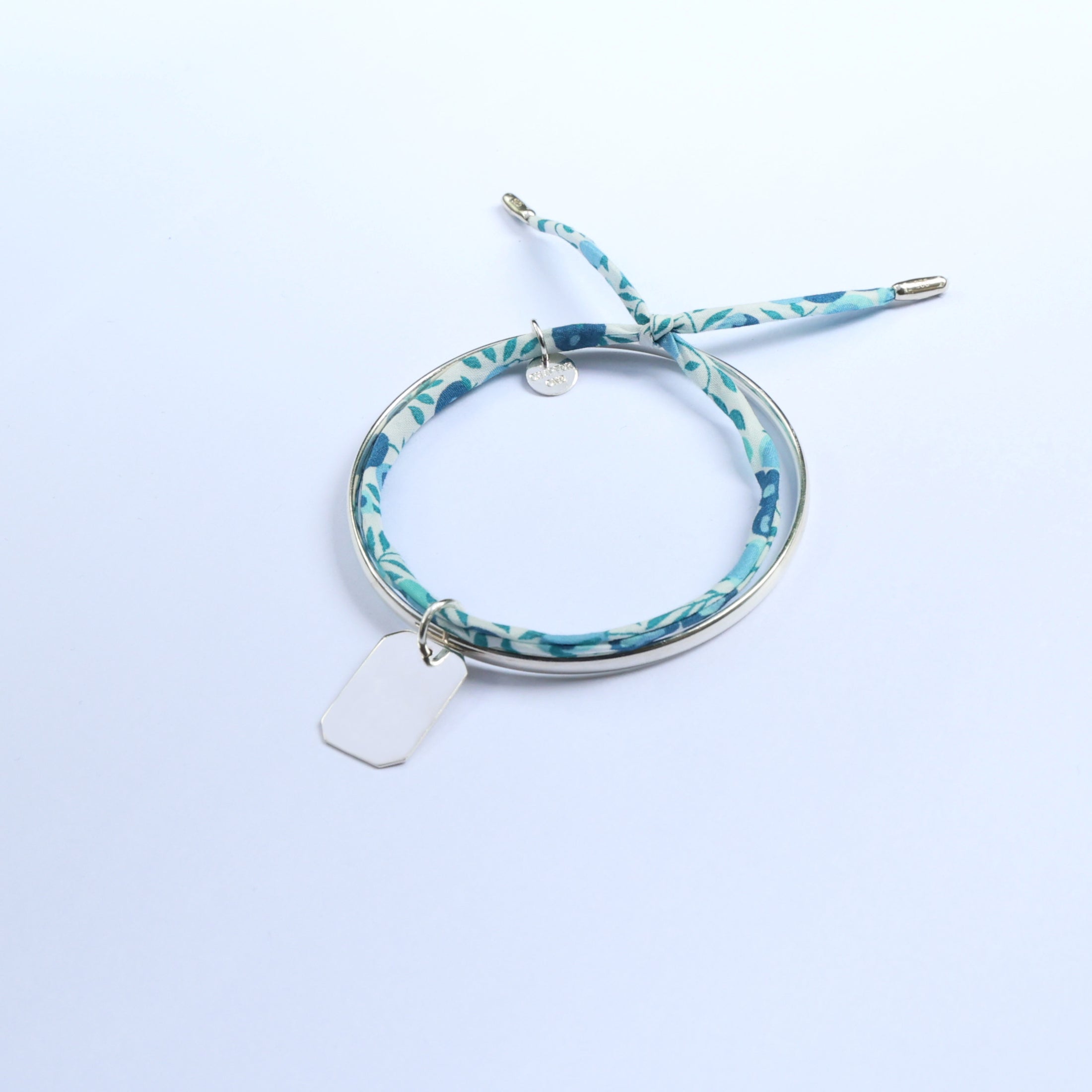 Silver bangle for women with bar pendant and light blue fabric