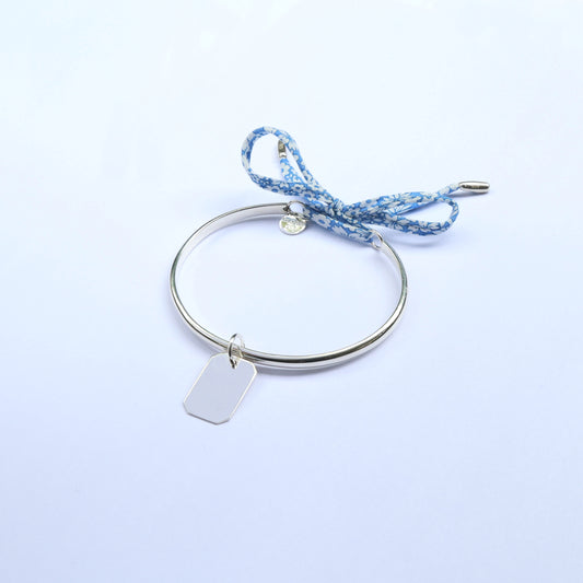 Silver Bangle with an engravable  bar pendant and a light blue cord 