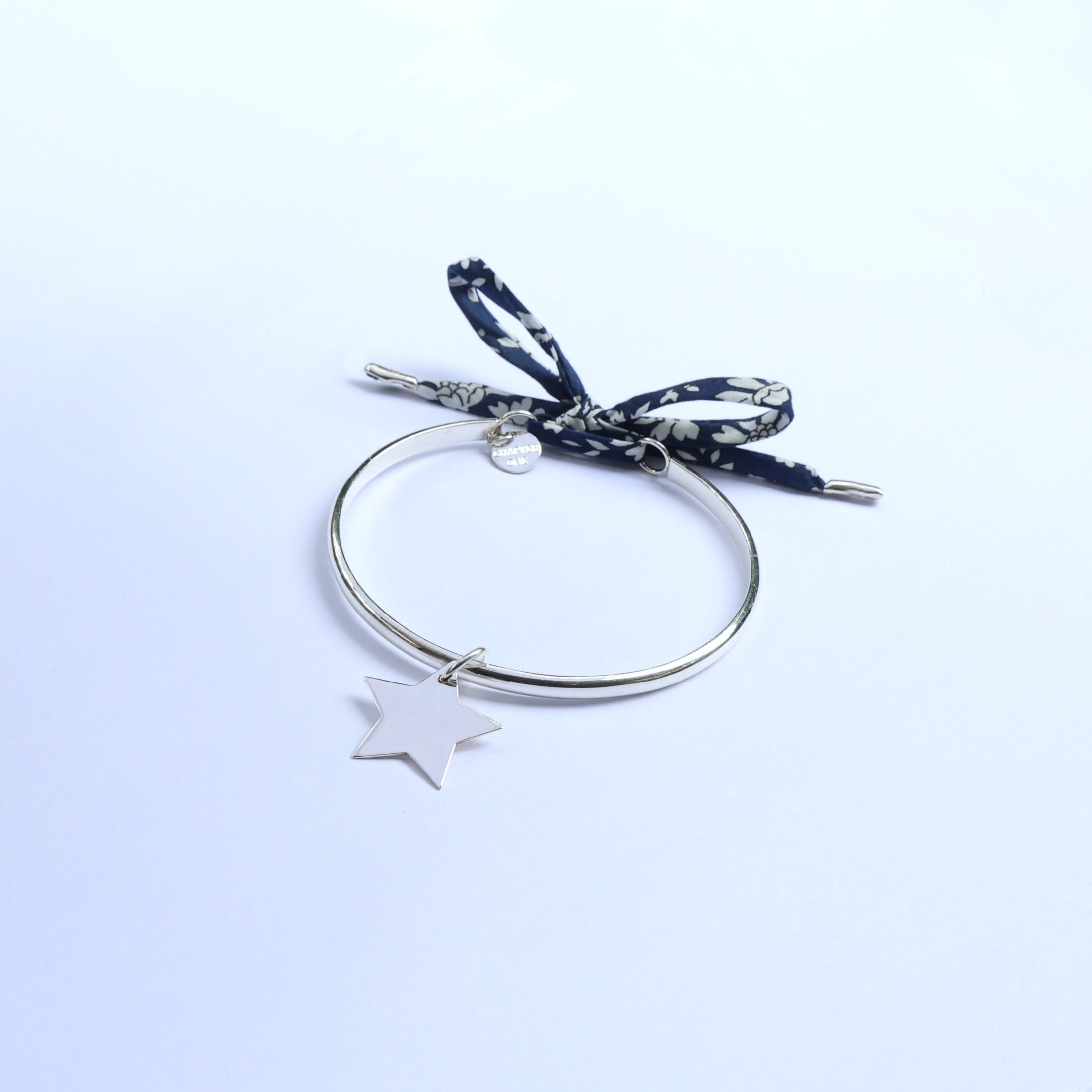 Silver bangle for mums with a star pendant and a navy blue ribbon 